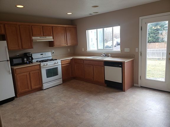 Open kitchen overlooks backyard with glass door
