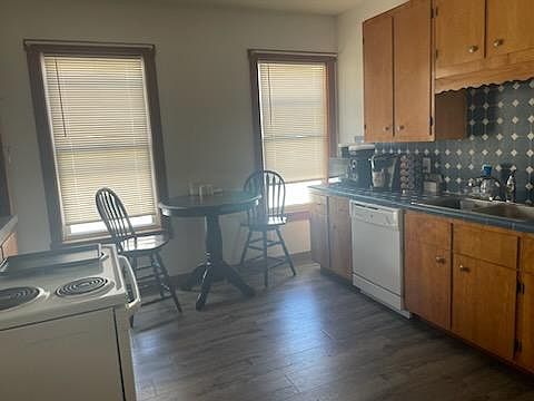 Kitchen area - refrigerator on opposite wall. wine/coffee station near the left window
