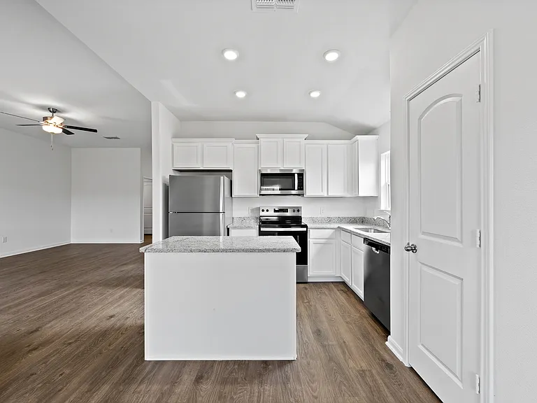 Chef-ready kitchen with white cabinets and granite countertops.