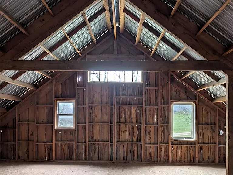 Upper level of the barn featuring rustic timber framing.