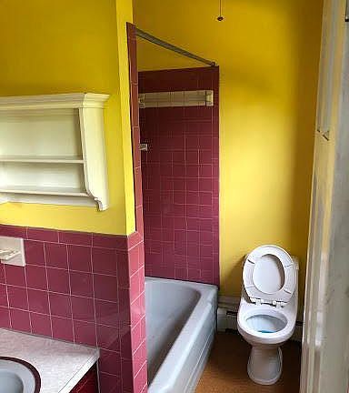 Bathroom, typical 4x12 galley style with small vanity shower/tub and cork flooring
