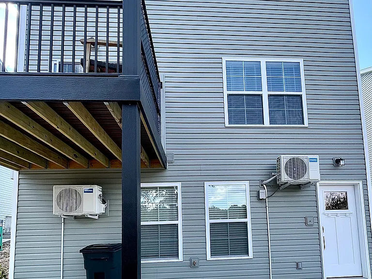 Posterior of home with private balcony and separate B Unit entrance on lower level.