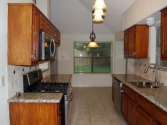 Kitchen with granite and stainless steel appliances