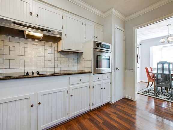 Updated stainless oven and vent hood. Notice the crown moulding in the kitchen and the flat ceiling has not popcorn.