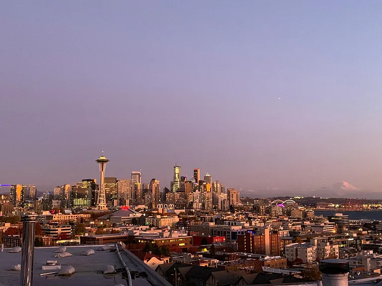 Enjoy the twilight Skyline, Space Needle and Mt Rainier from the rooftop deck .