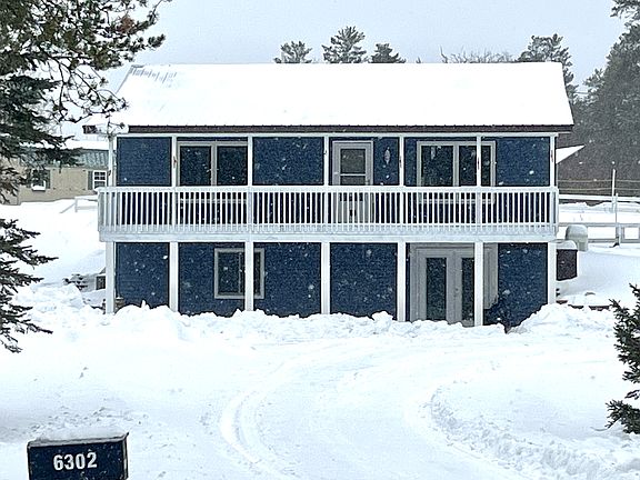 Two story with front and back porch and walkout basement. Circle driveway.