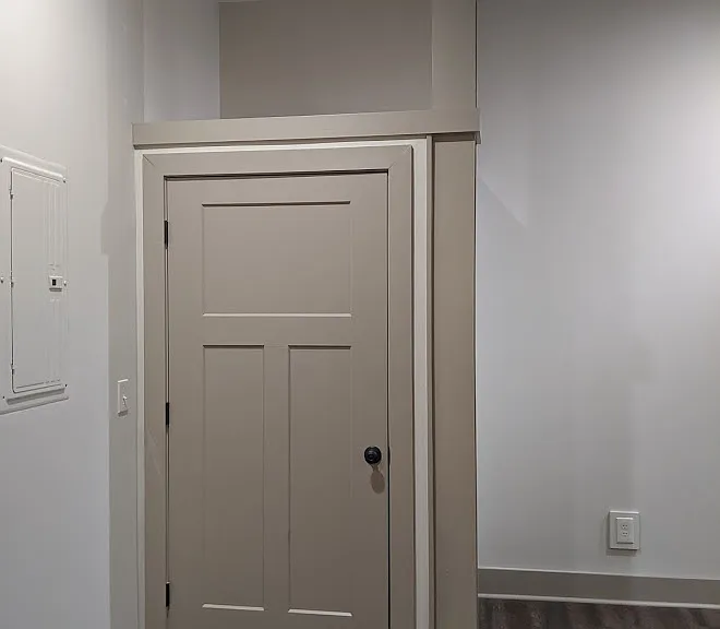 Washer/Dryer Closet, closed, with exposed steel support beam.