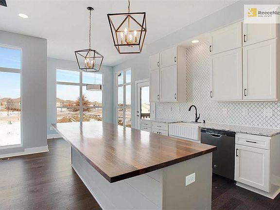 Custom walnut hardwood island counter top.  Beautiful custom tiled walls and granite counter tops.