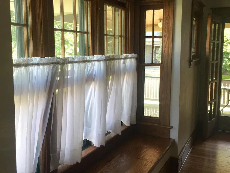 Living room, bay window, porch doors.
