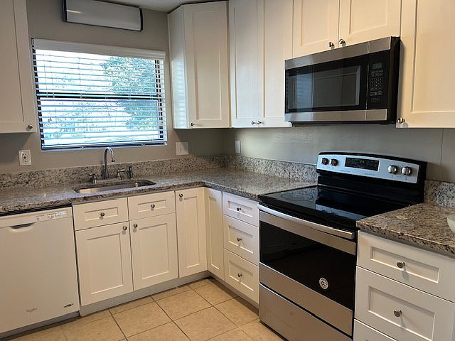 Well appointed kitchen with new cabinets and granite counter-tops.