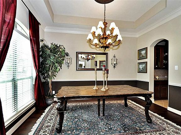  DINING ROOM IS LOCATED TO THE LEFT OF THE ENTRY WITH IMPRESSIVE UPGRADED CHANDLIER