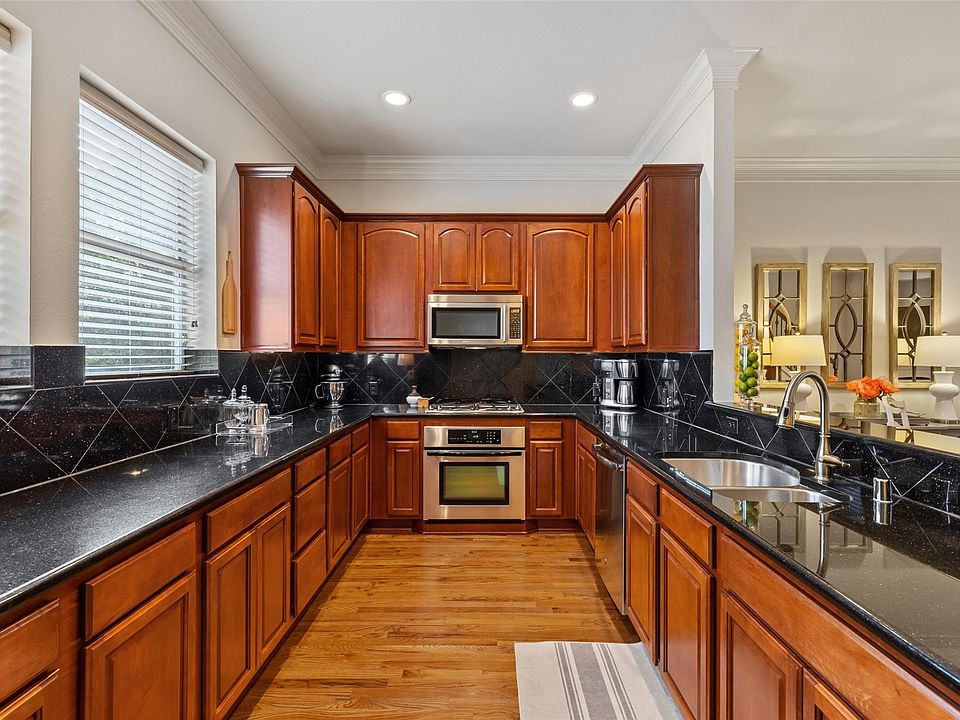 Open Kitchen with granite counters, wood cabinets with a ton of storage. Stainless appliances including refrigerator! Large windows that open!