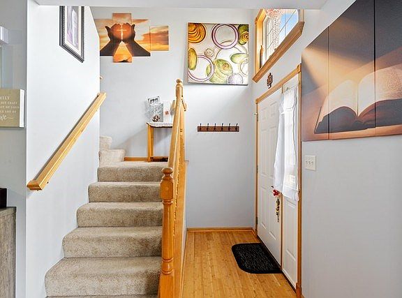 Half open stairway with a large window over the front door for abundant natural light!