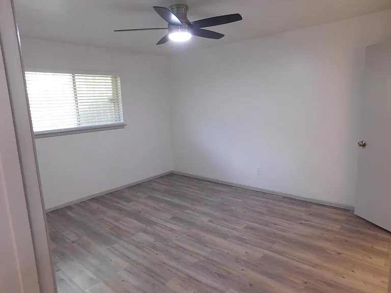 Second bedroom with one-half bath with stack washer and dryer, and walk-in closet.