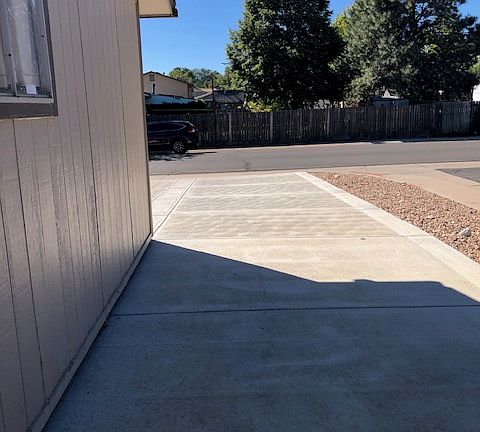 Side of house with concrete walkway