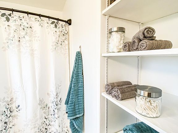 Bathroom- tub/shower, toilet, vanity, large mirror, built-in linen cabinet