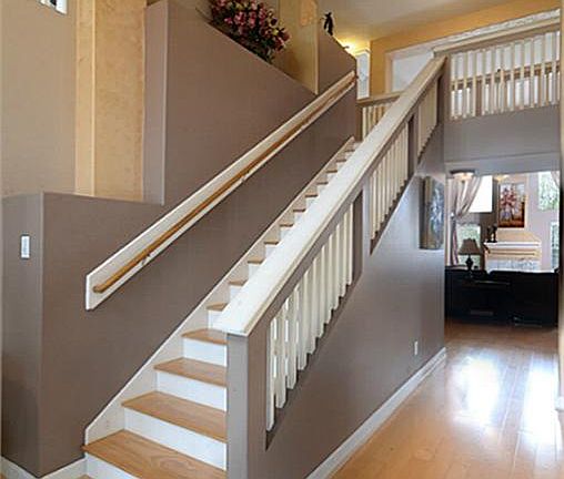 Guests enter the home and are greeted by an impressive 2-story Foyer with hardwood floors and grand "California style" staircase