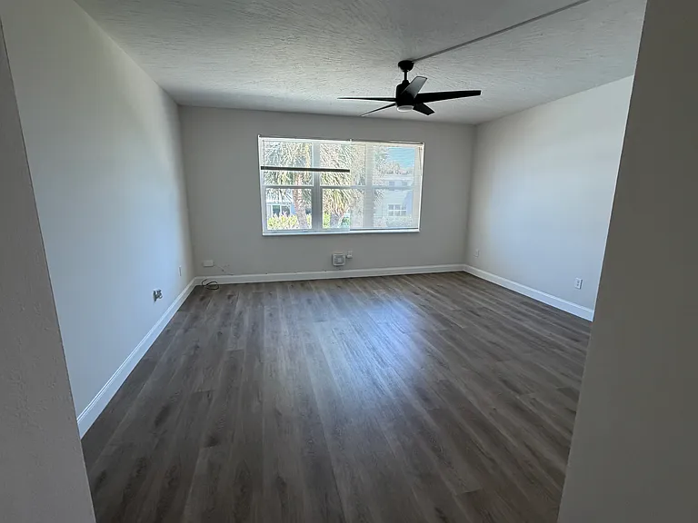 Main Living Space; can easily accommate large TV, large couch, end-tables and dining table. Elevated ceiling and fan. Side note, open the windows and get the million dollar sea breeze.