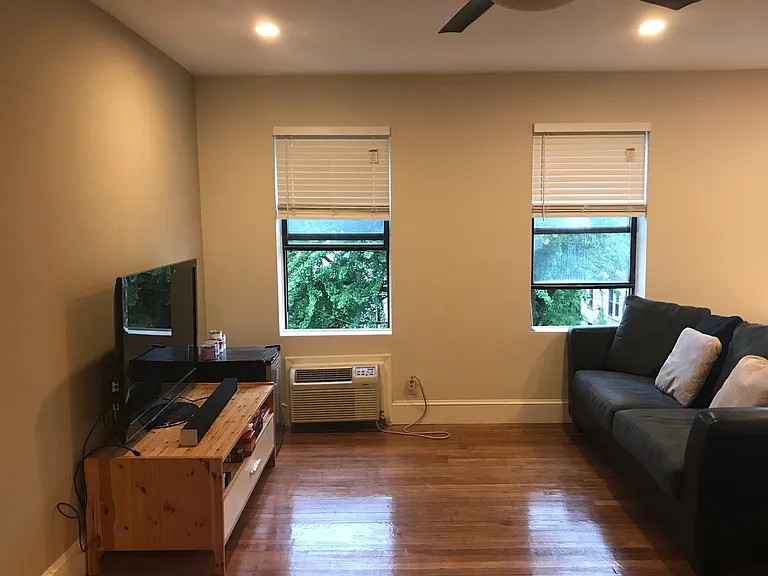 Open floor plan- furnished living room with sofa and entertainment center