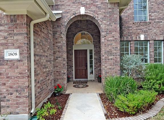 Greet your guests from this lovely landscaped entry.