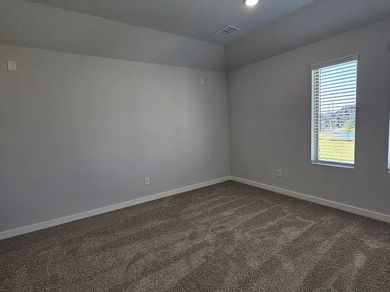 This expansive media room is the ultimate bonus to complete the home, offering the perfect setup for family entertainment and movie nights.