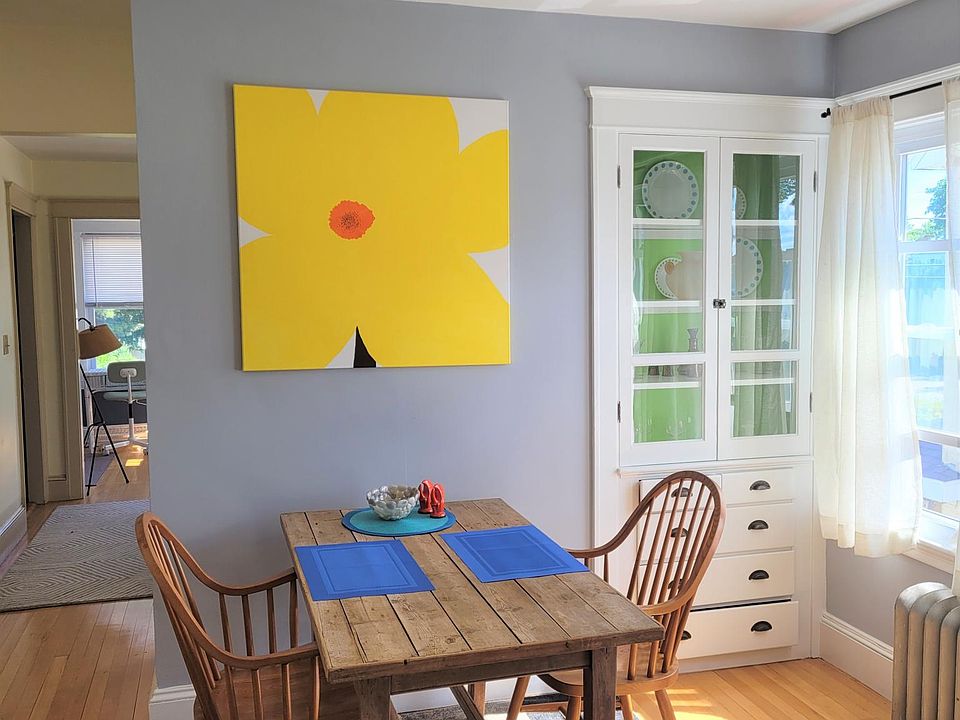 Bright and airy dining room with an original Susan Thomas painting.