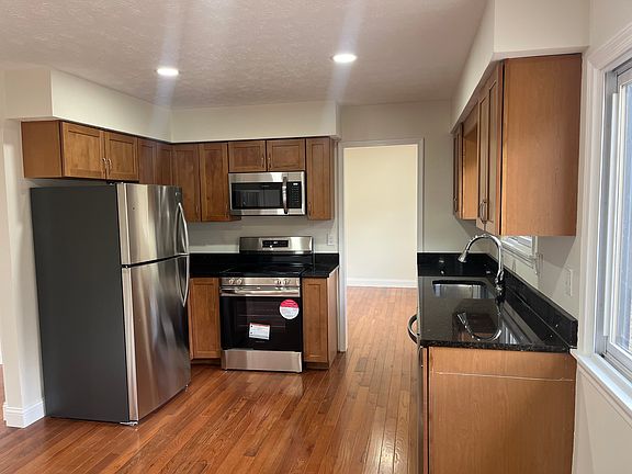 View of kitchen with new stainless steel appliances and granite countertops