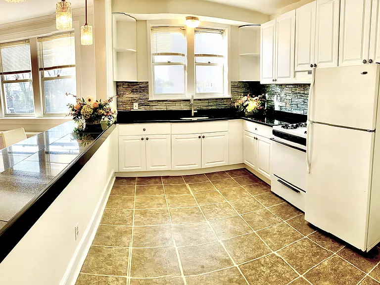 Kitchen and counter opening to living room