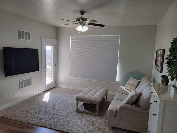 Living Room with door to outer deck. Private BBQ area.