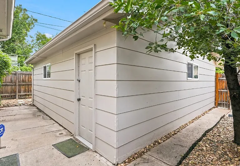 HUGE TWO car garage with tool bench inside and three parking spaces behind the garage as well.