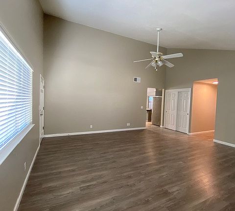 Large living room with vaulted ceilings and wood burning fireplace