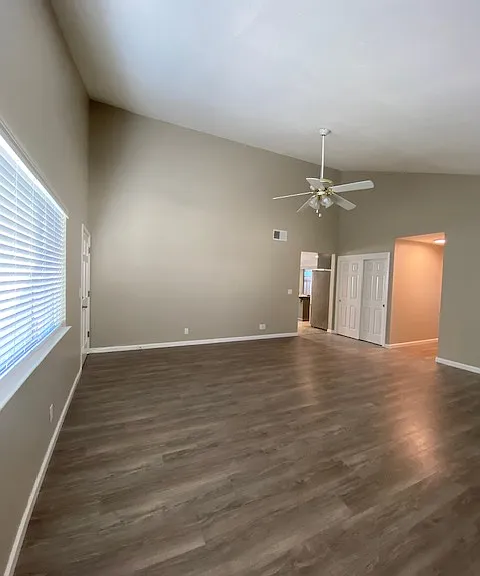 Large living room with vaulted ceilings and wood burning fireplace