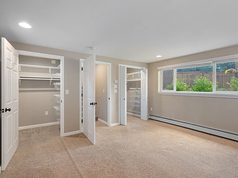 Primary bedroom walk-in closets.