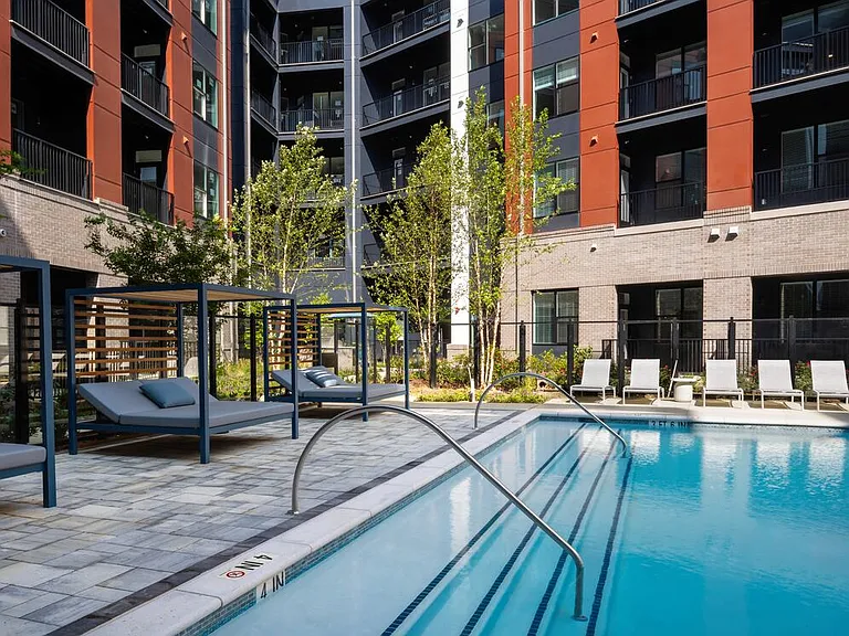 Resort-style pool and sundeck with cabanas