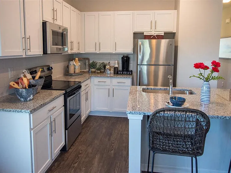 Kitchen nook showcasing ample storage/cabinet space and a stainless steel refrigerator.