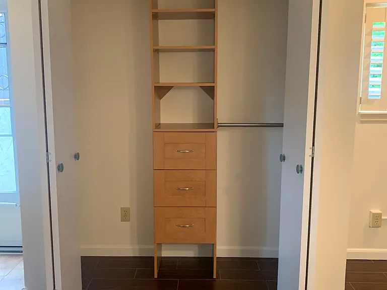 closet with built in drawers and shelves