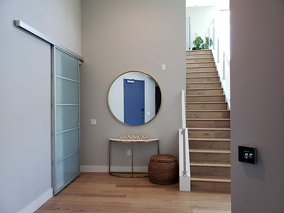 Foyer, entrance to laundry room, stairs to loft