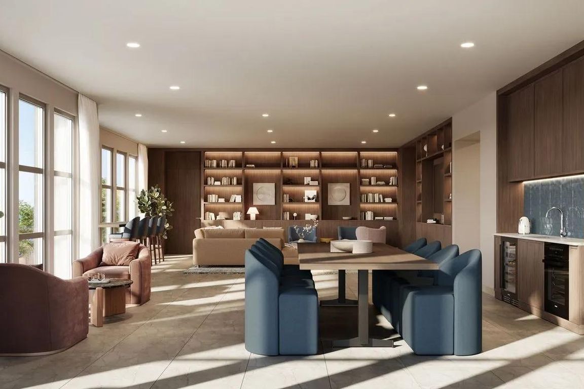Sky lounge with custom built-ins, communal dining space, and lounge seating arranged for conversation or quiet co-working.