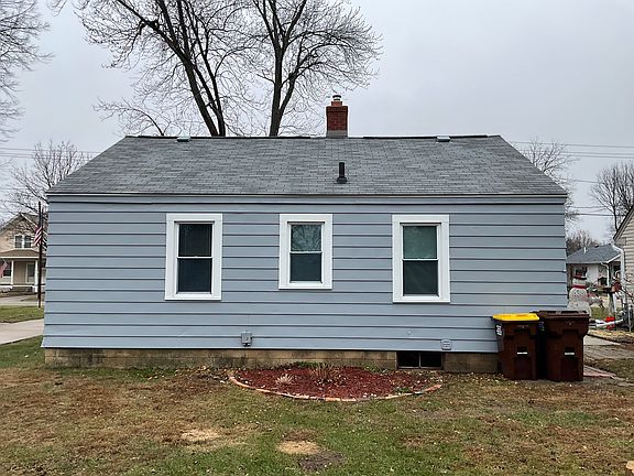 Rear of home, show bedroom windows on left and right, center window is bath