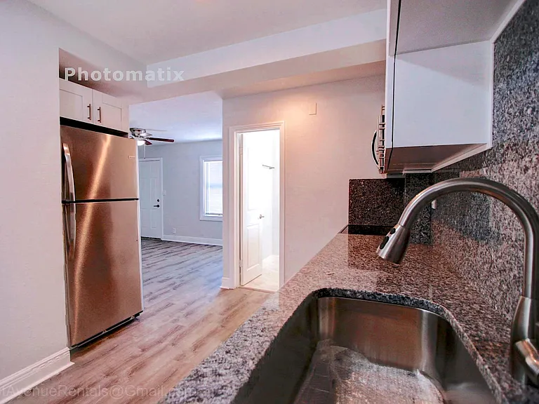 View of oversized kraus stainless steel sink paired with american standard pull down faucet, all the granite, bathroom and living room