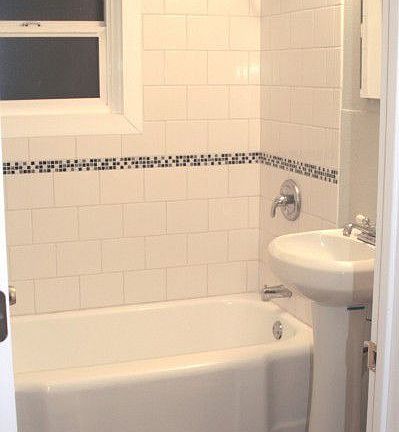 All new bath features white tile with a mosaic tile inset detail. New toilet, new pedestal sink and 