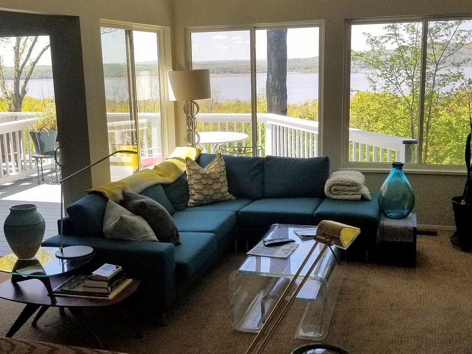 Sunken living room area with expansive Hudson view and large deck.