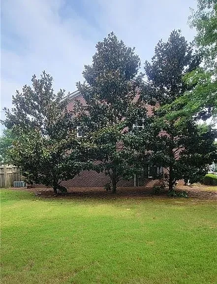 Beautiful end unit with gorgeous magnolia trees add to privacy.