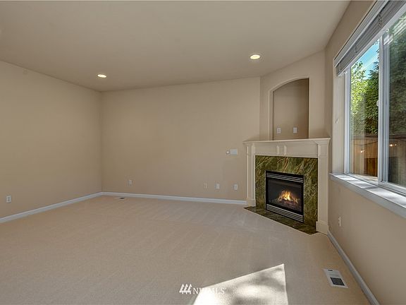 Elegant corner fireplace warms the room and offers media niche above. 