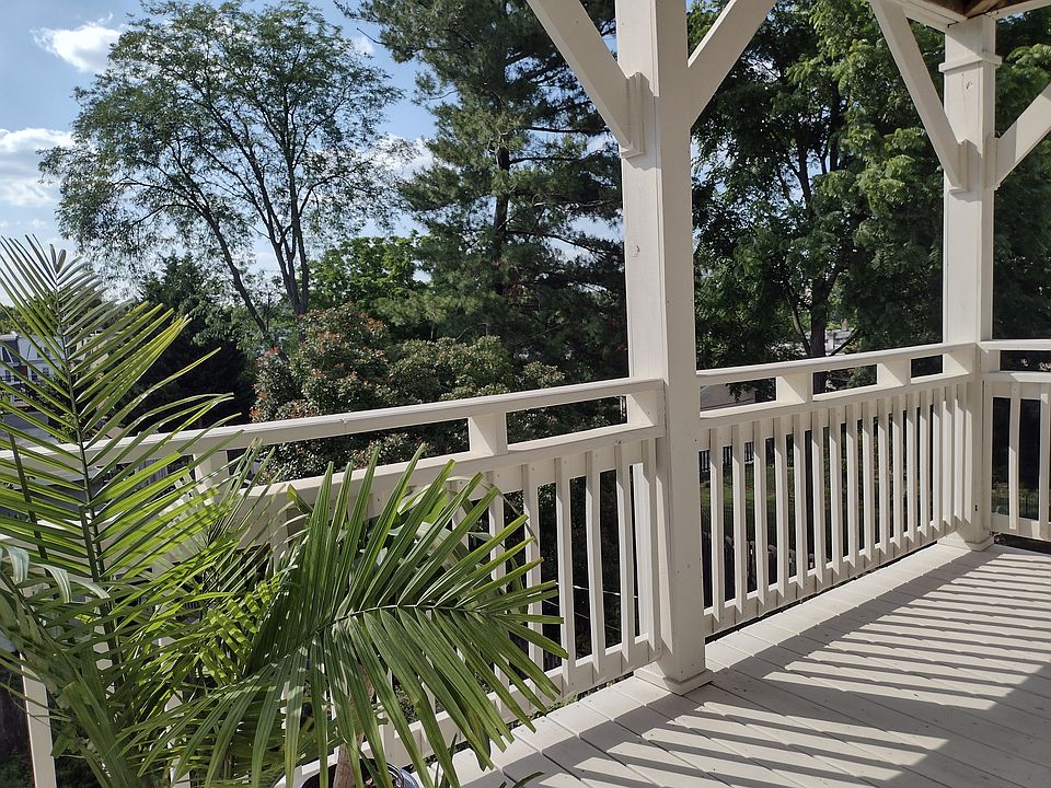 Large full-length deck set in a lovely pine tree and deciduous tree canopy, overlooks the back garden and lilacs, and runs the length of the living room