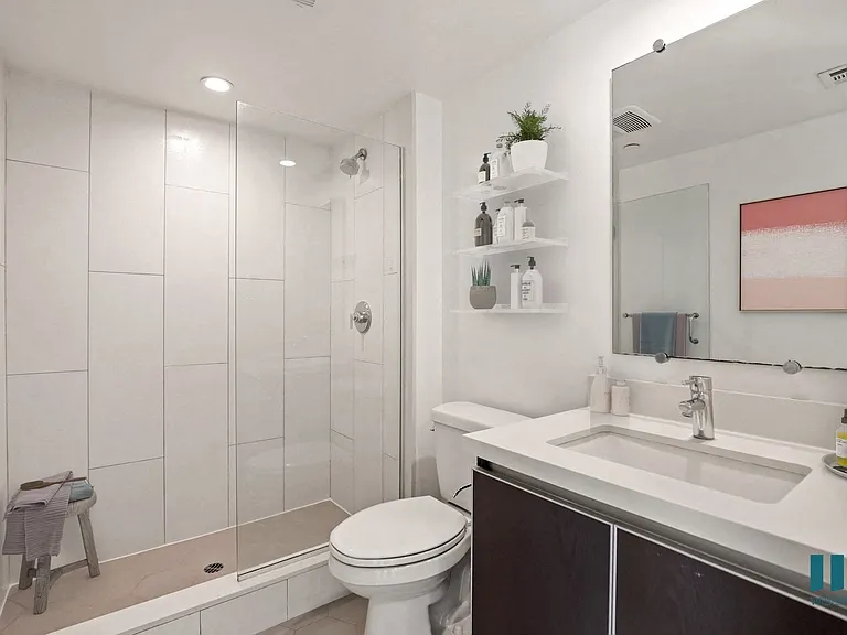 Bathroom with Large-Size Walk-In Shower with Glass Door and Vanity Cabinet Storage