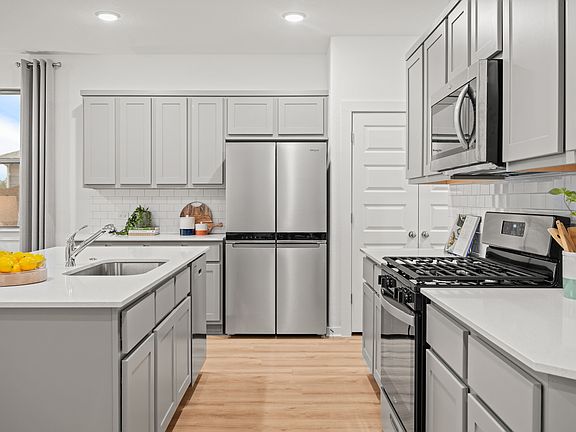 Kitchen in the Oak home plan by Trophy Signature Homes - REPRESENTATIVE PHOTO