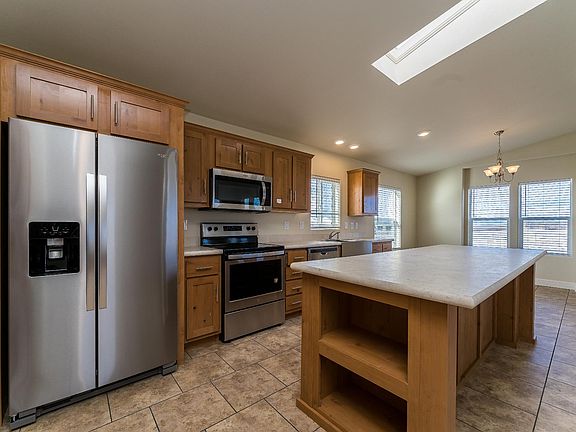 Kitchen - Solid wood cabinets, upgraded stainless appliance package, upgraded nickel hardware, large kitchen island, title back splashes, country farm sink, skylight, recessed lighting.