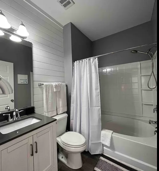 Updated private en suite bath off the master bedroom with oversized soaker tub/shower combo.