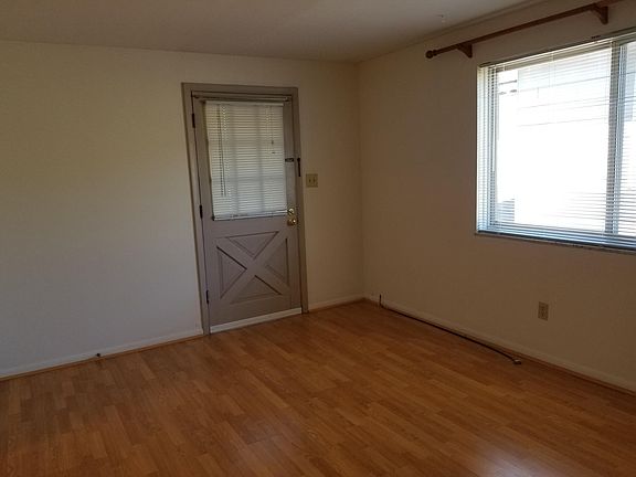 Front room showing front door and window. Maple Laminate floors.